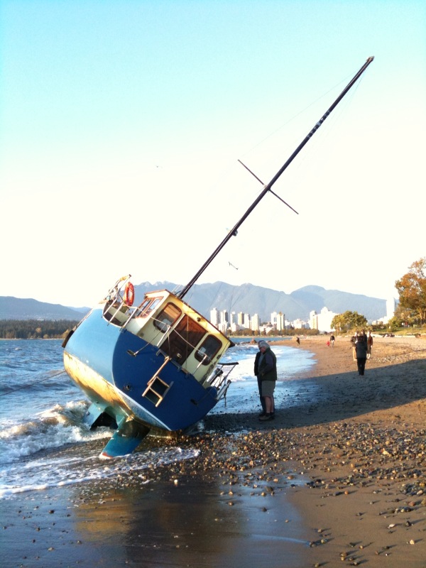 Sailboat washed up at Kits beach Sailboat washed up at Kits beach