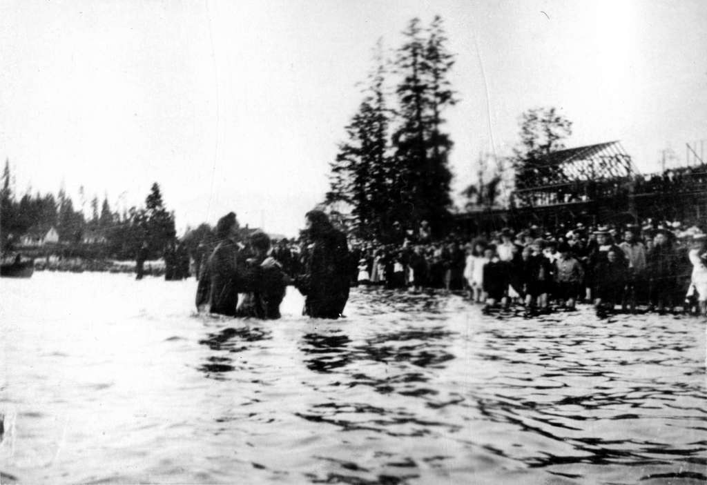 Woman being baptized by the Reverends Christmas and Fair in English Bay Omage: Vancouver Archives